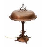 Art Deco A hammered copper and wrought iron table lamp, the shade with white enamelled inside,