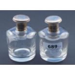 Pair of perfume bottles, with silver stoppers, inner stoppers are present, one bottle with chip, h.