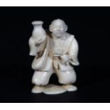 Ivory netsuke, Man with lotus flower, signed, h. 5 cm. 27.00 % buyer's premium on the hammer price,