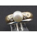 Bicolour gold ring, 14 krt., set with pearl and 6 brilliant cut diamonds, tot. appr. 0.30 crt.,