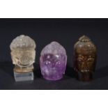 Three Buddha heads, tiger's eye, rock crystal and amethist, h. appr. 5 cm (3x) 27.00 % buyer's