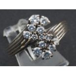 White gold ring, 14 krt., set with 10 brilliant cut diamonds and 3 zircons, ring size 19 1/2 27.