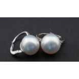 White gold earrings, 18 krt., set with Southsea pearl appr. 11 mm. and four diamonds 27.00 % buyer'
