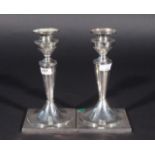 Two silver candlesticks, 19th century, 835, with loose fat catchers/bobeches, empire-style, some