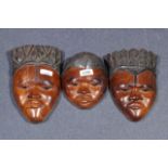 Three African reliefs in the shape of a female head, man's head and a child's head, dim. 18-21