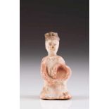 A kneeled feminine figure Terracotta sculpture with traces of polychromy Possibly Tang Dynasty