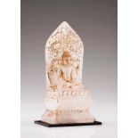 A seated Buddha Rock crystal sculpture Depicting a seated Buddha on a pedestal and carved stele