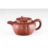 A Yixing tea pot Zisha clay Fluted body with engraved decoration and cover finial shaped as lion