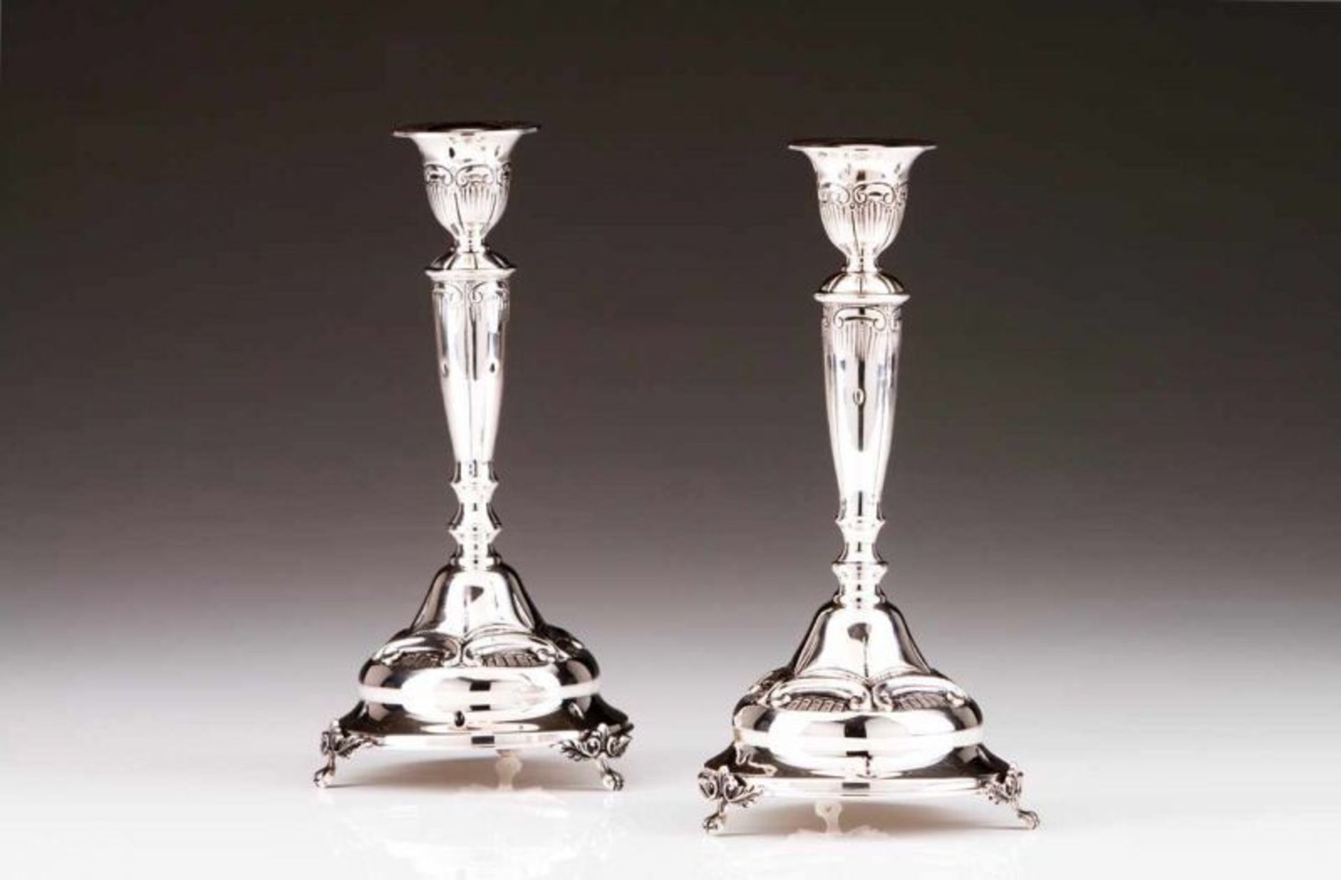 A pair of candlesticks Portuguese silver On three claw feet, decorated with volutes Porto assay