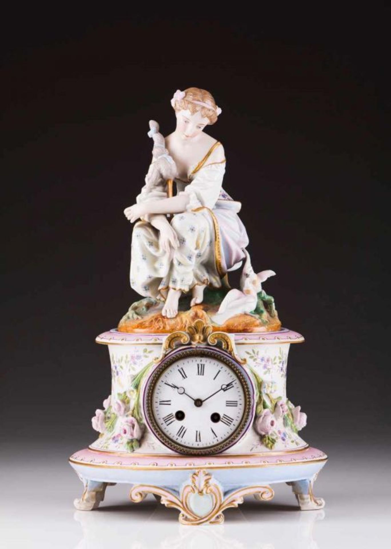 A table clock Polychrome biscuit porcelain representing spinner and floral motifs Enamel dial