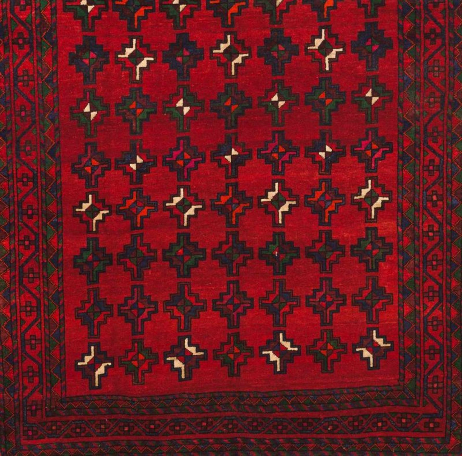 A Baluchi carpet, Iran Cotton and wool Geometric decoration in red, green and blue 305x185cm