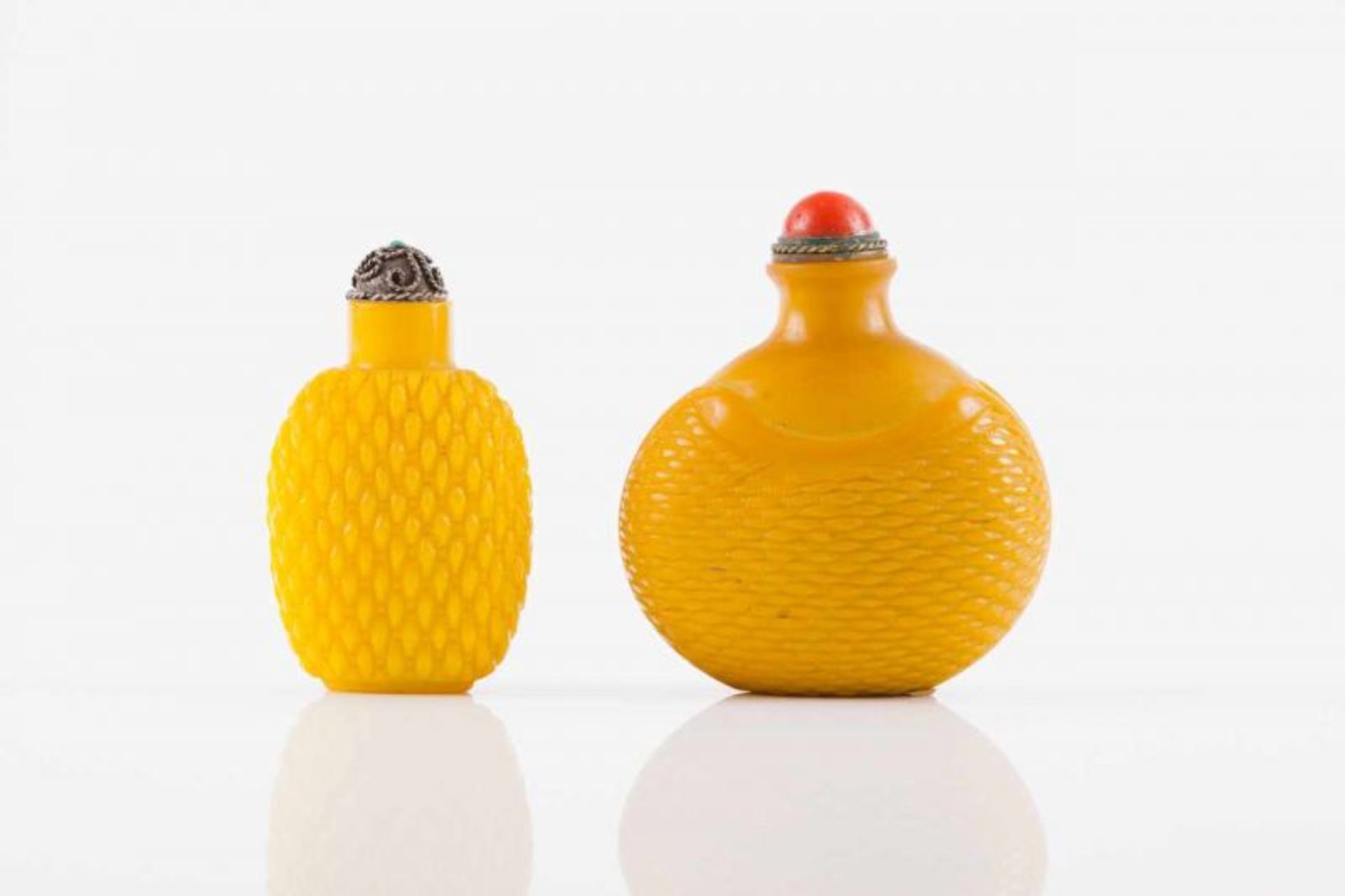 Two snuff-bottles Opaque yellow glass Relief decoration with plaid pattern Silvered metal covers