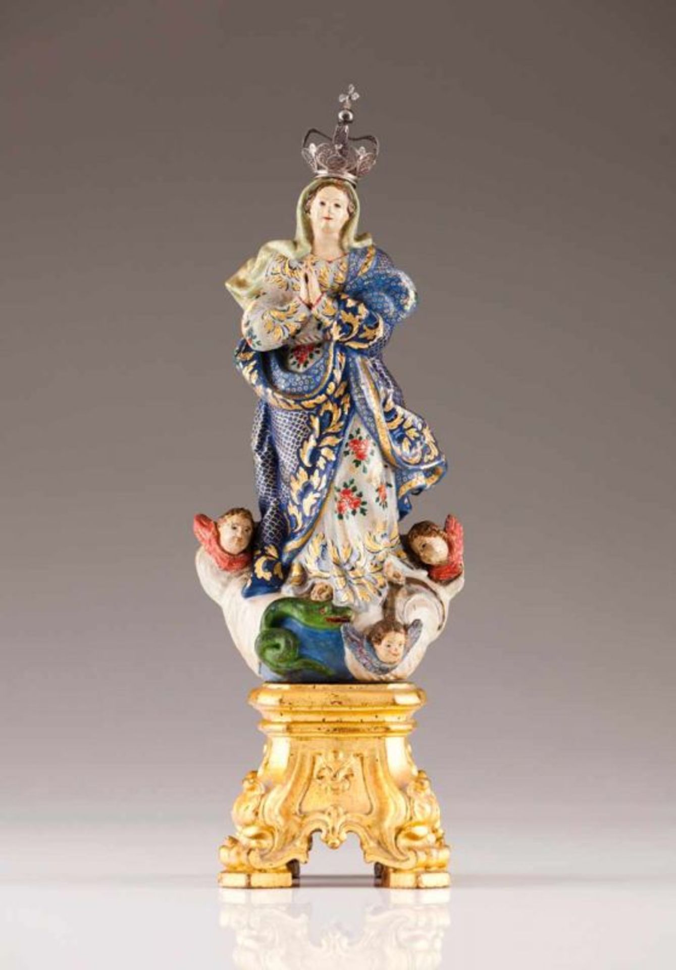 Our Lady of the Conception Polychrome and gilt wood Carved and gilt wood base Silver crown