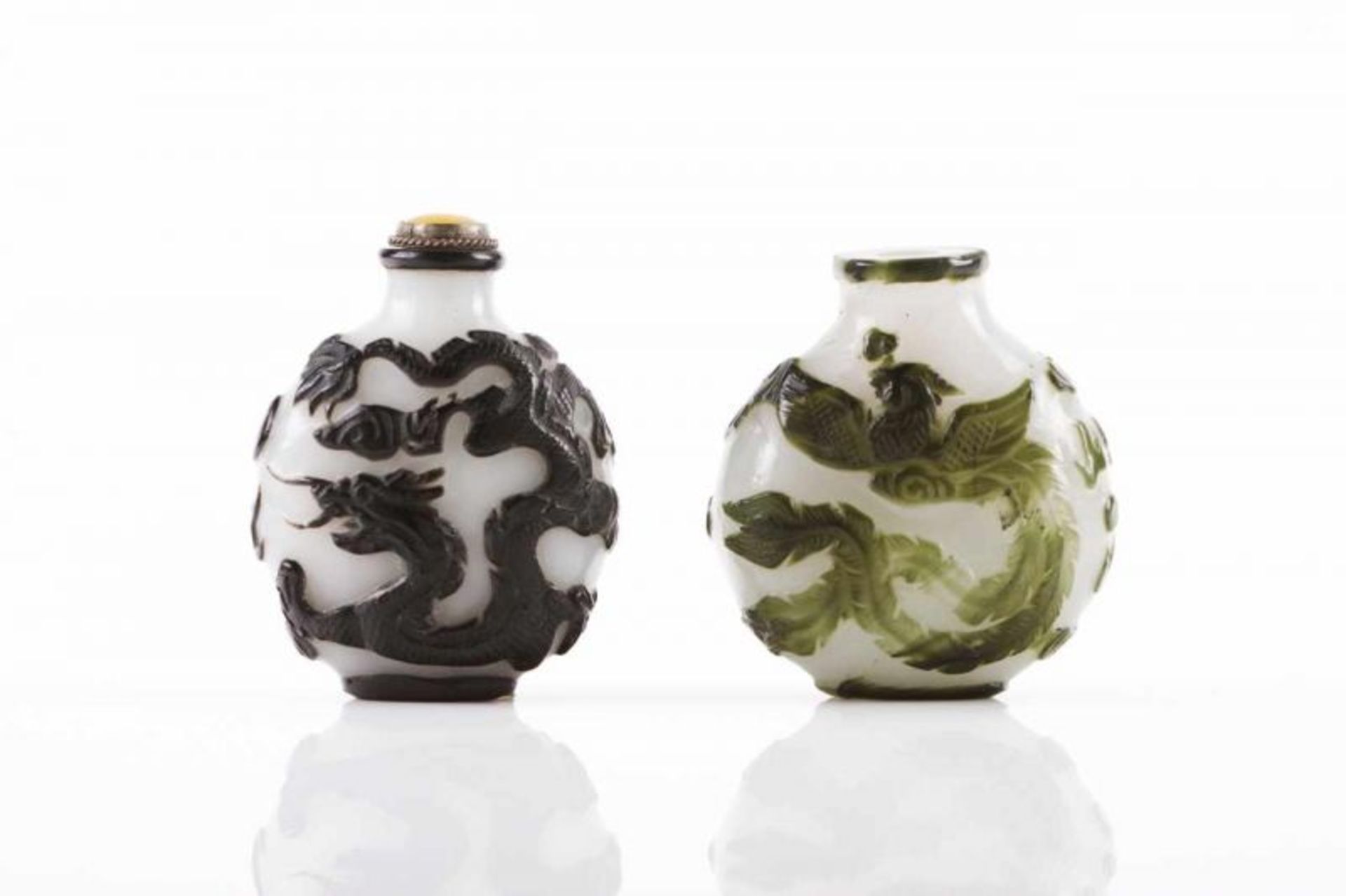 Two snuff-bottles Two-toned glass One with black engraved decoration, the other with green engraved