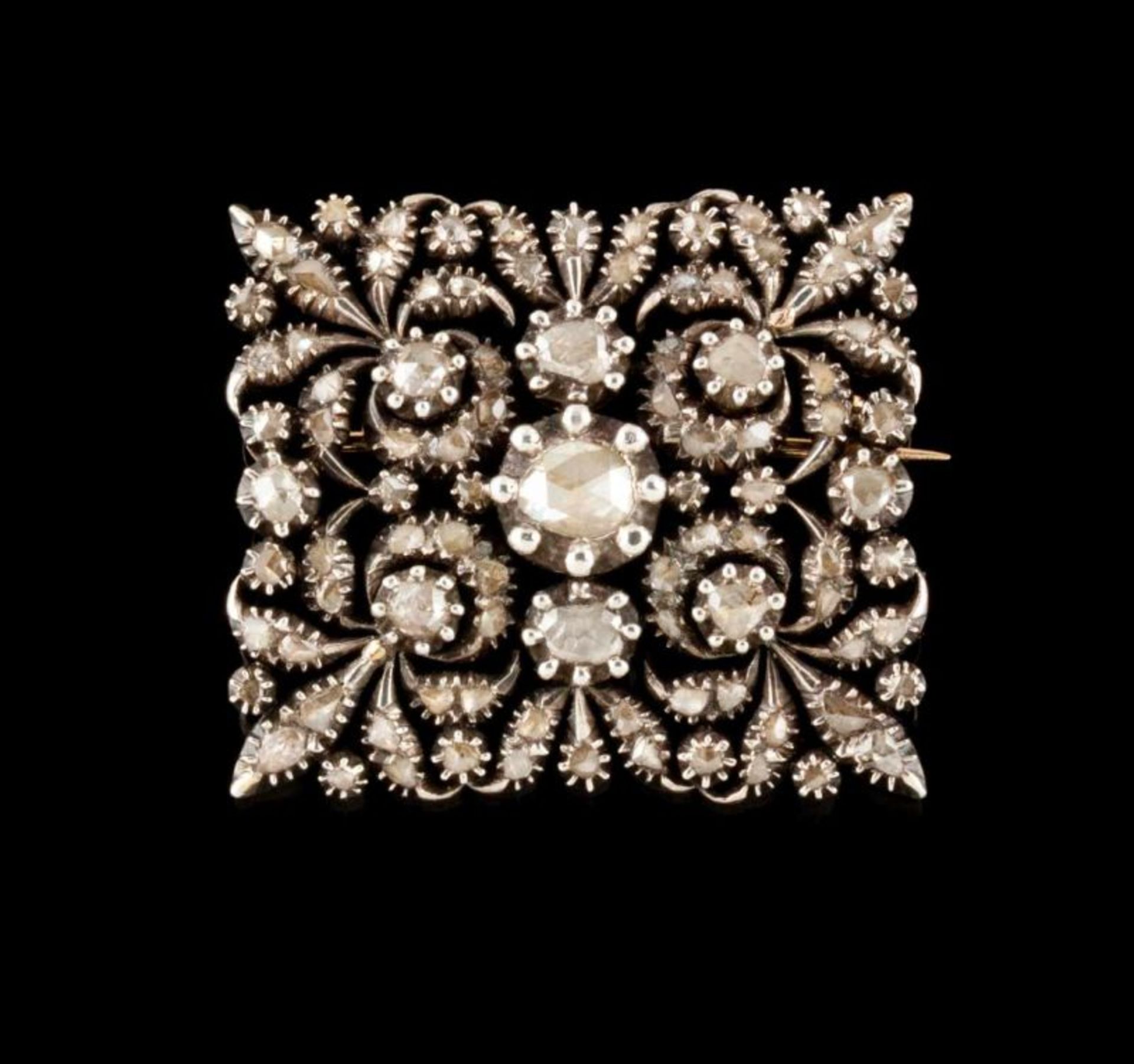 A brooch Set in silver and gold with foiled rose cut diamonds Decorated with crescents and floral