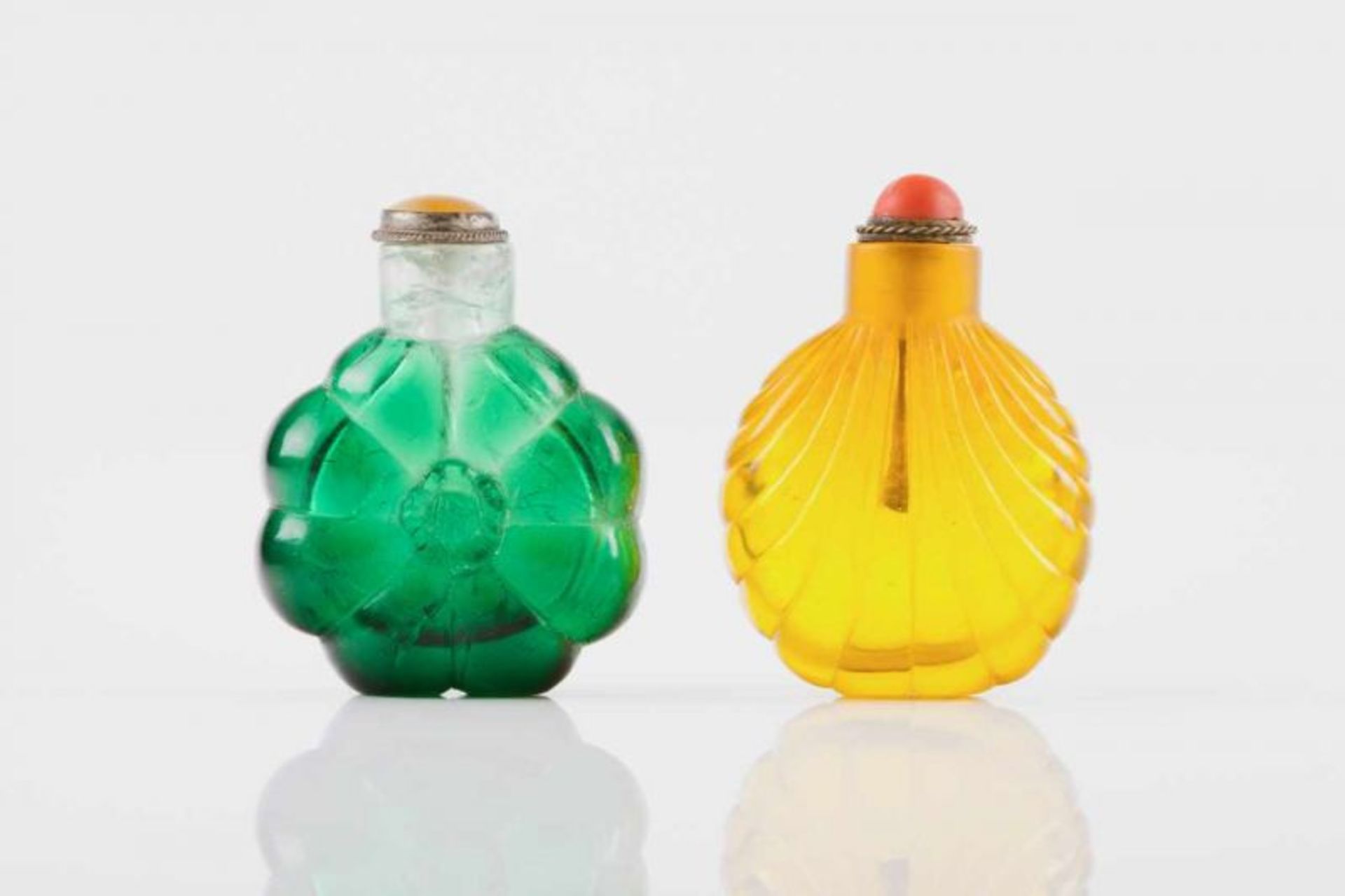 Two snuff-bottles Translucent yellow and green glass olded decoration Metal and hardstones covers