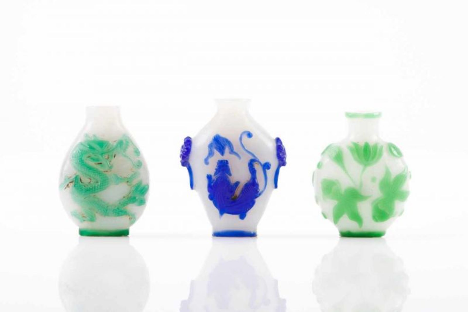 Three snuff-bottles Two-toned glass Blue and green engraved decoration on white opaque ground