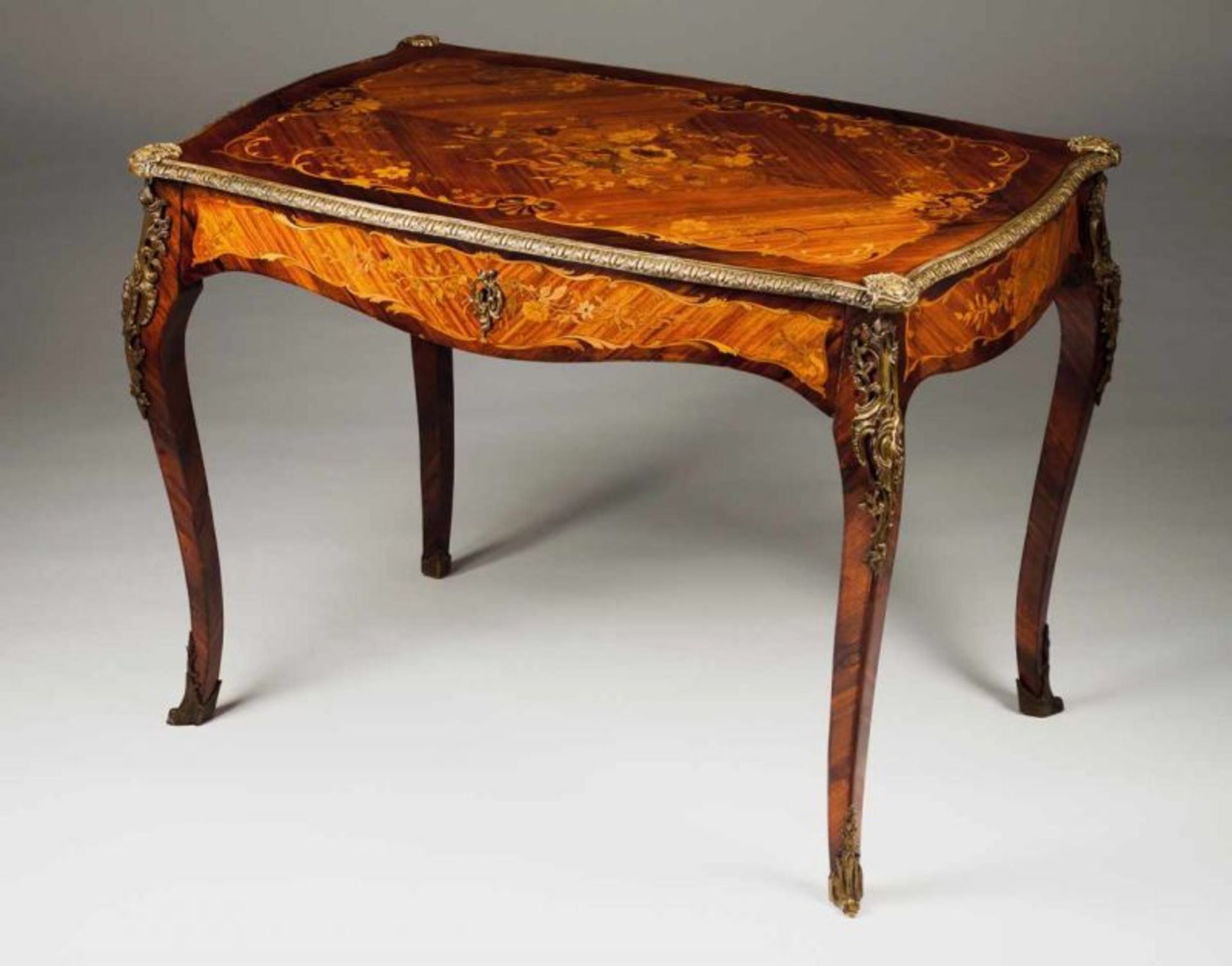 A bureau plat Rosewood with marquetery decoration depicting shell and floral motifs and scrolls