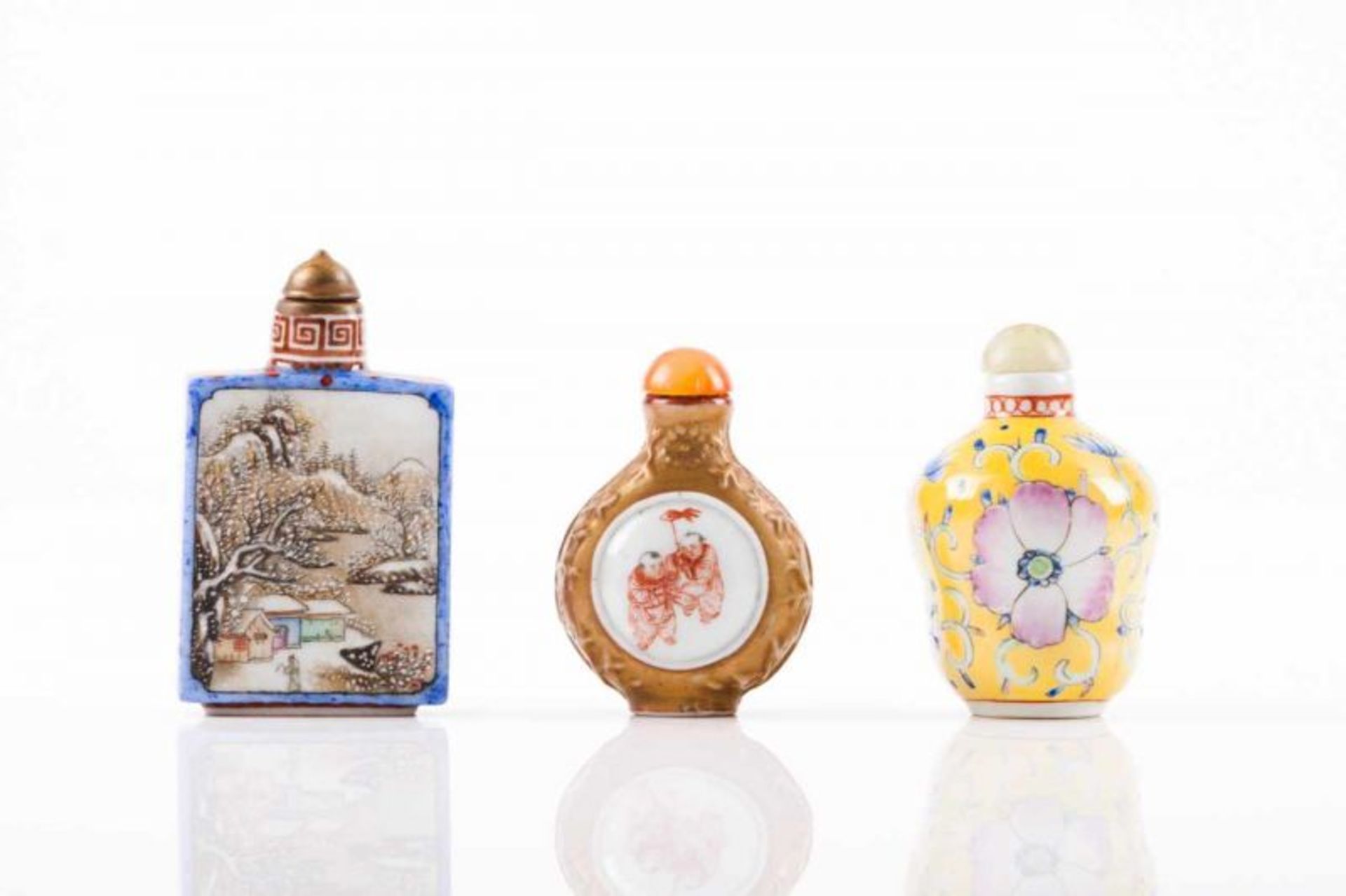 Three snuff-bottles Chinese porcelain Polychrome decoration One decorated with winter landscapes