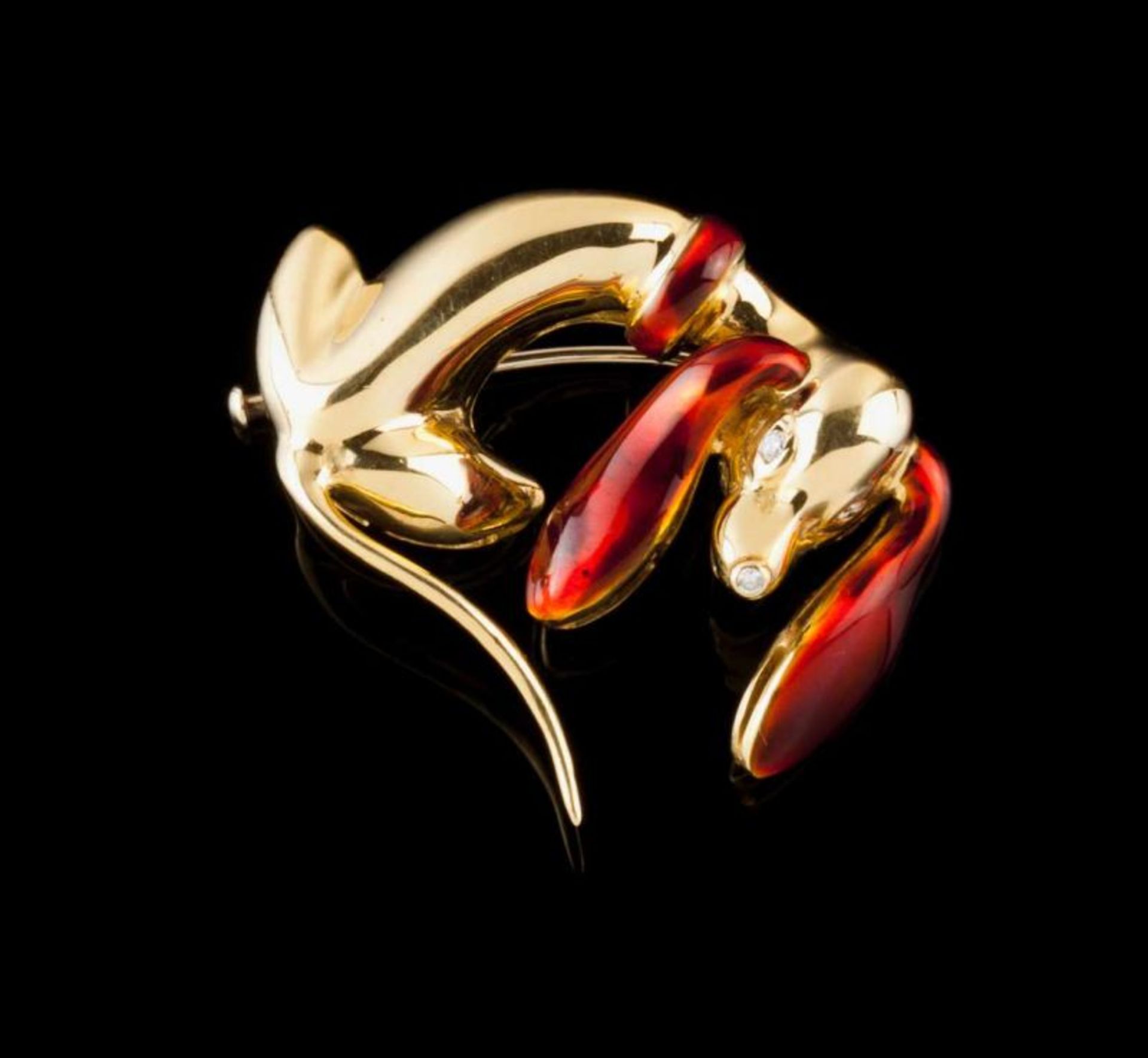 A brooch, GARAVELLI Gold enamelled in red and set with three small brilliant cut diamonds Designed