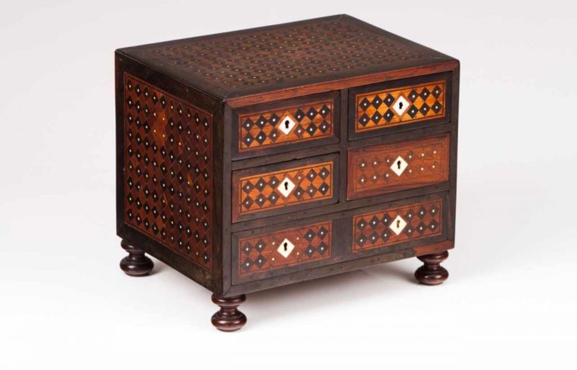 A small Indo-Portuguese cabinet Teak partly veneered in ebony Ebony and ivory inlaid decoration