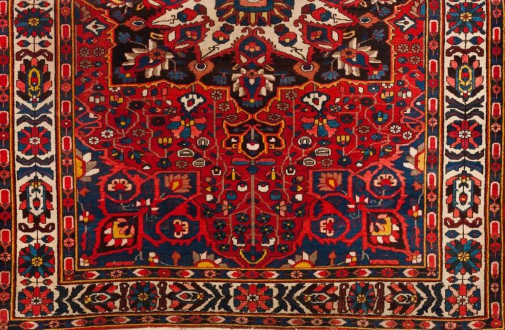 A Bakhtiari carpet, Iran Cotton and wool Floral decoration in blue, red, beige and yellow (wear