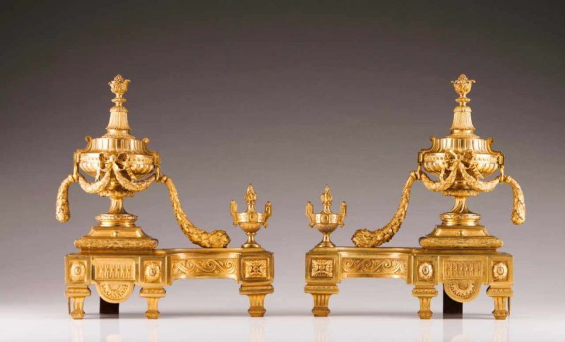 A pair of Napoleon III chenets Gilt bronze Chiselled relief decoration depicting urns, garlands and