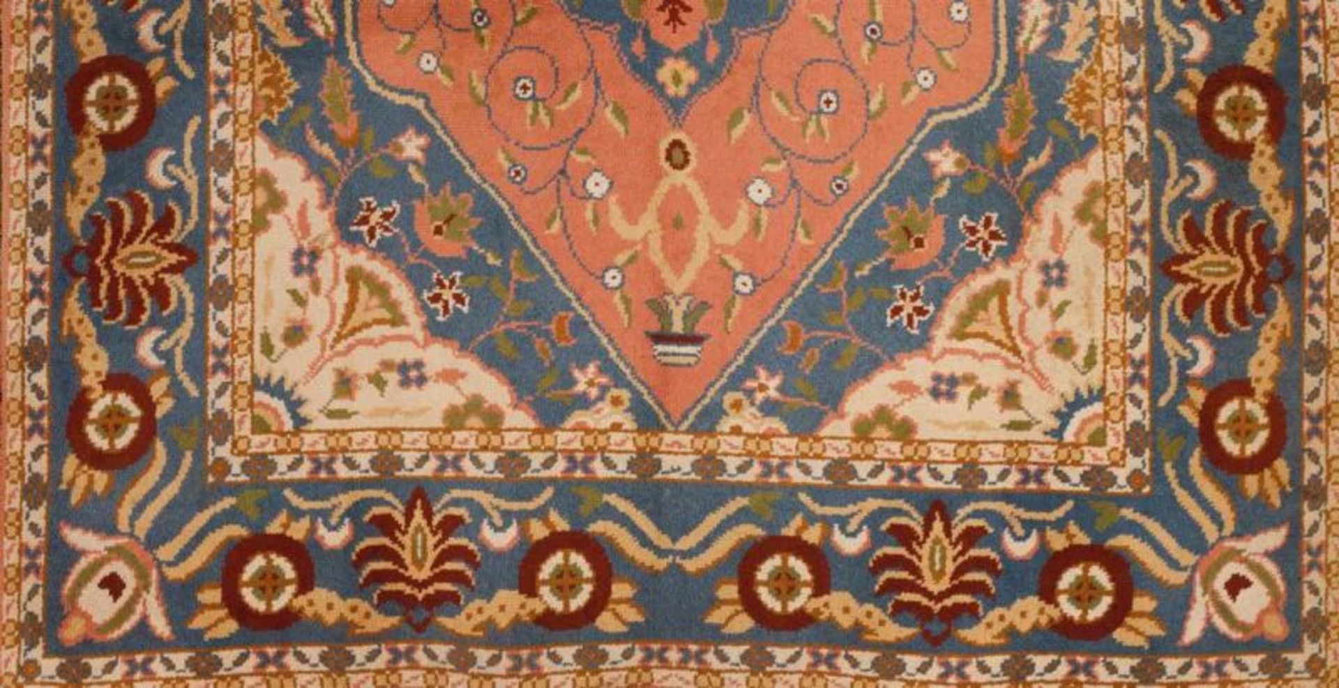 A Tabriz carpet Cotton and wool of floral design with central cartouche in blue, pink and beige