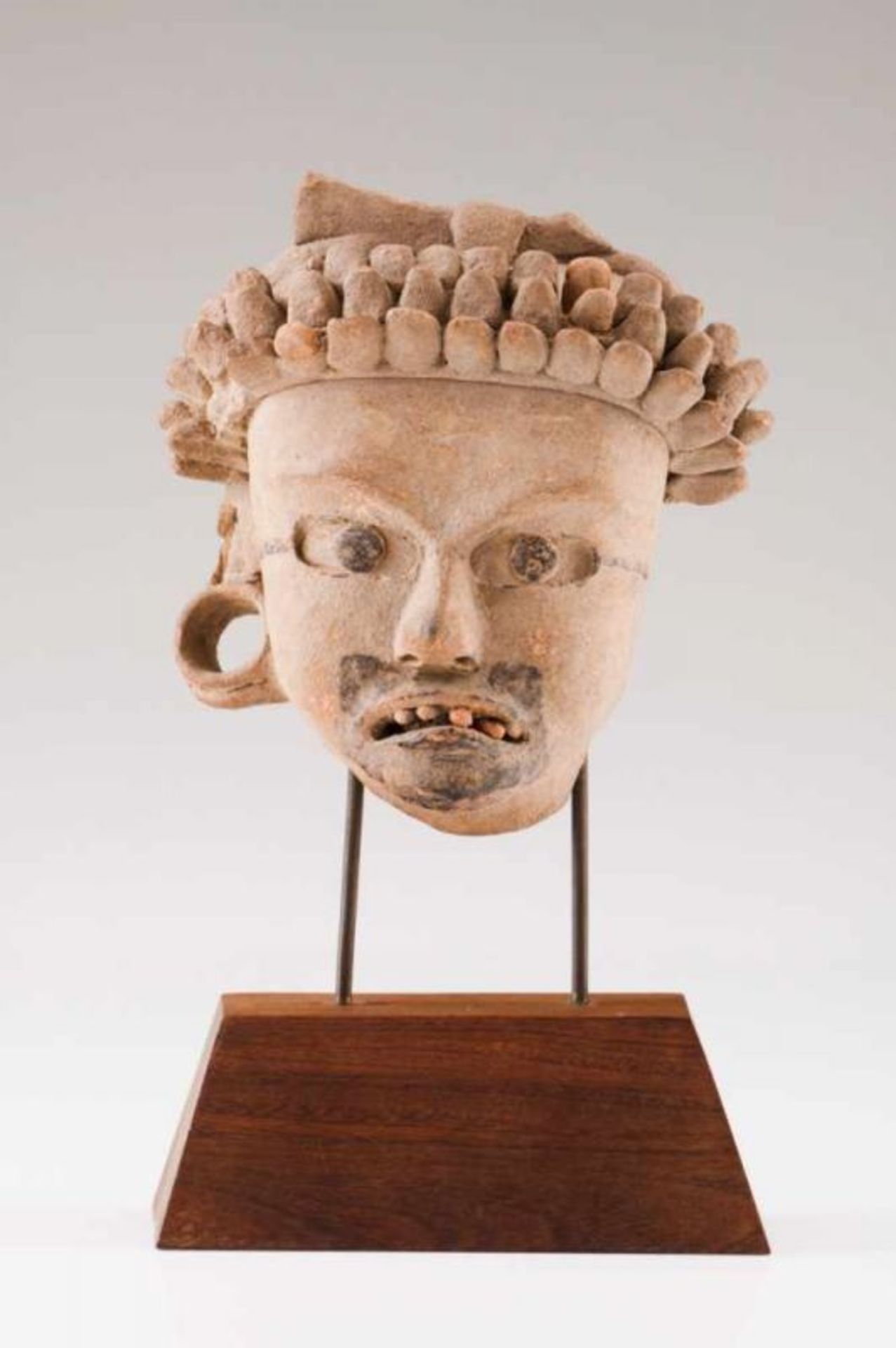 A warrior's head Terracotta sculpture with bitumen application and traces of polychromy Mexico,