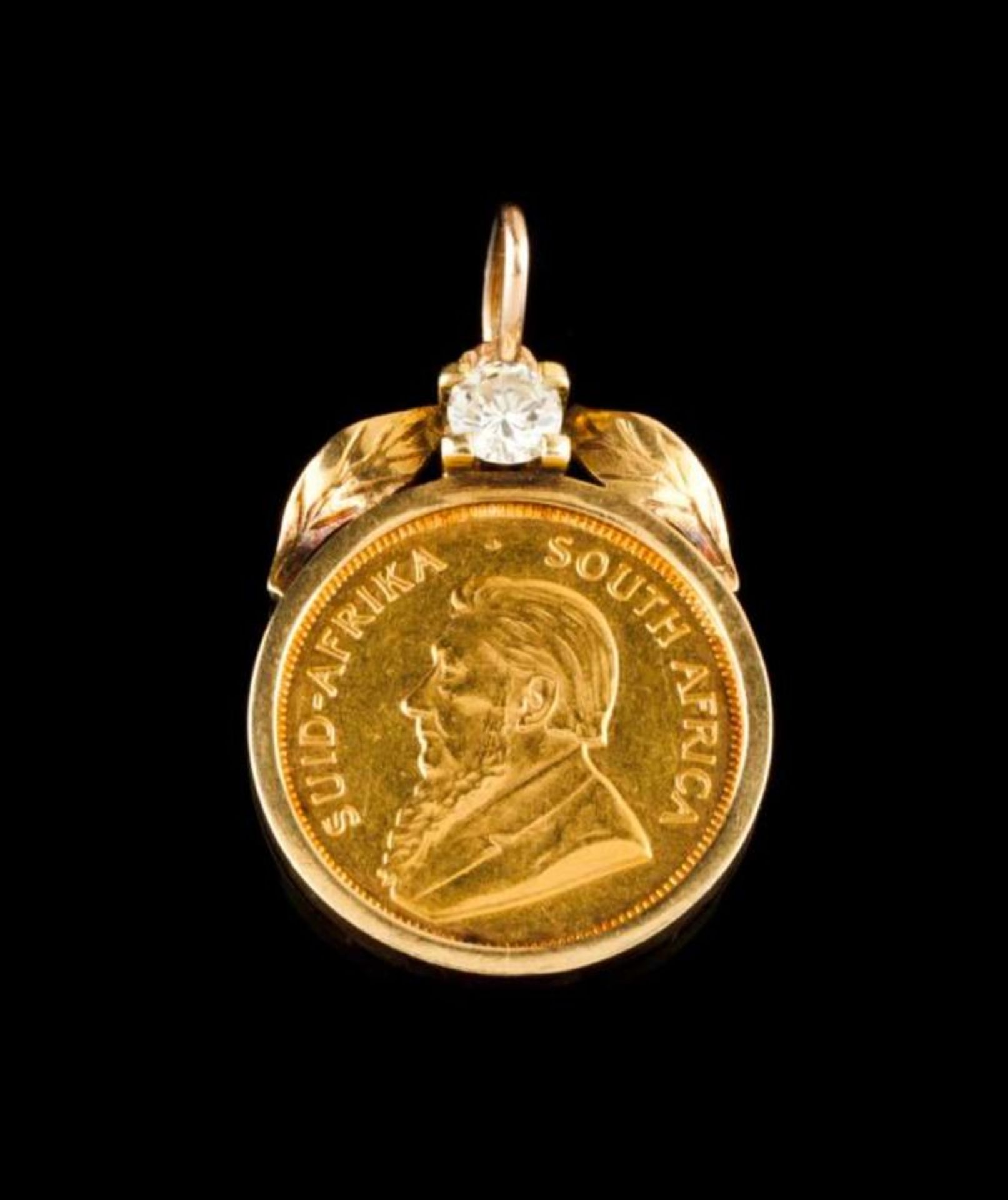 A pendant 14kt gold frame set with a brilliant cut diamond weighing approx. 0,50ct and a 1/4