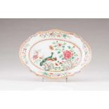 A scalloped oval dish Chinese export porcelain Polychrome Famille Rose decoration depicting garden