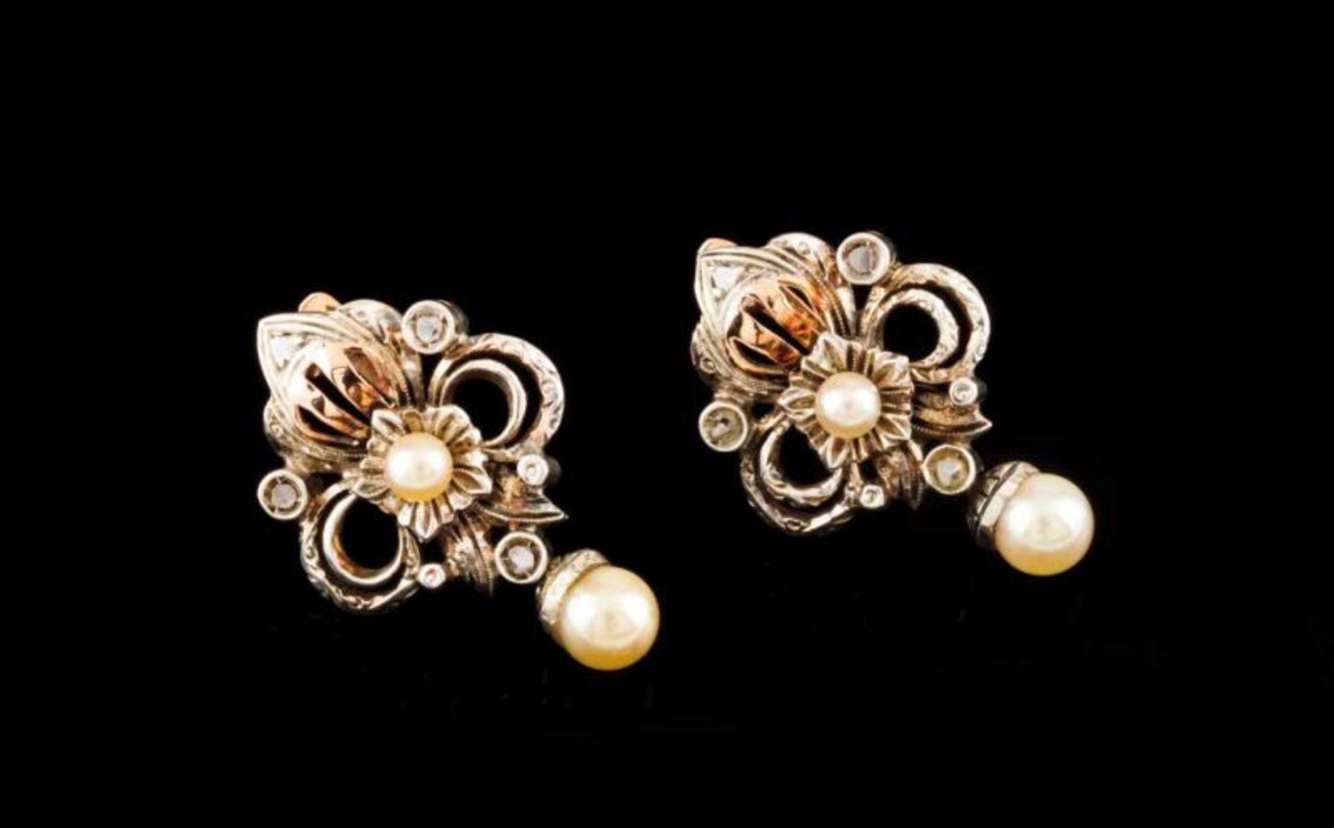 A pair of earrings Set in silver and gold with cultured pearls and rose cut diamonds Designed as a