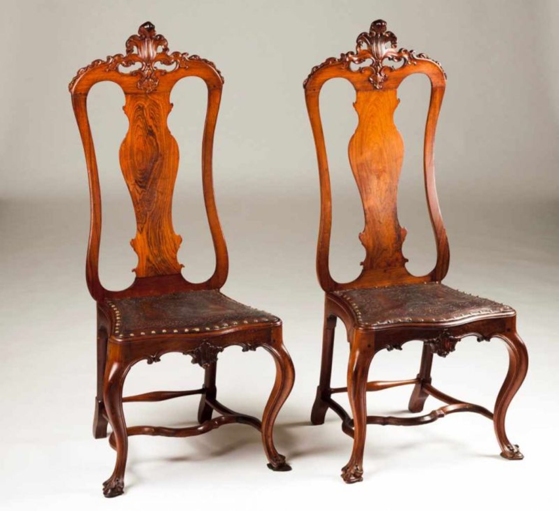 A pair of D. José (1750-1777) chairs Rosewood Pierced and scalloped backs Engraved leather seats