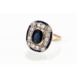 An Art Deco ring Set in gold and platinum with calibrated sapphires, one oval cut sapphire and