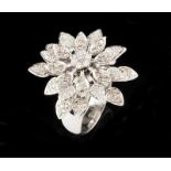 A ring 18kt white gold Designed as a flowers with articulated petals Paved with 151 brilliant cut