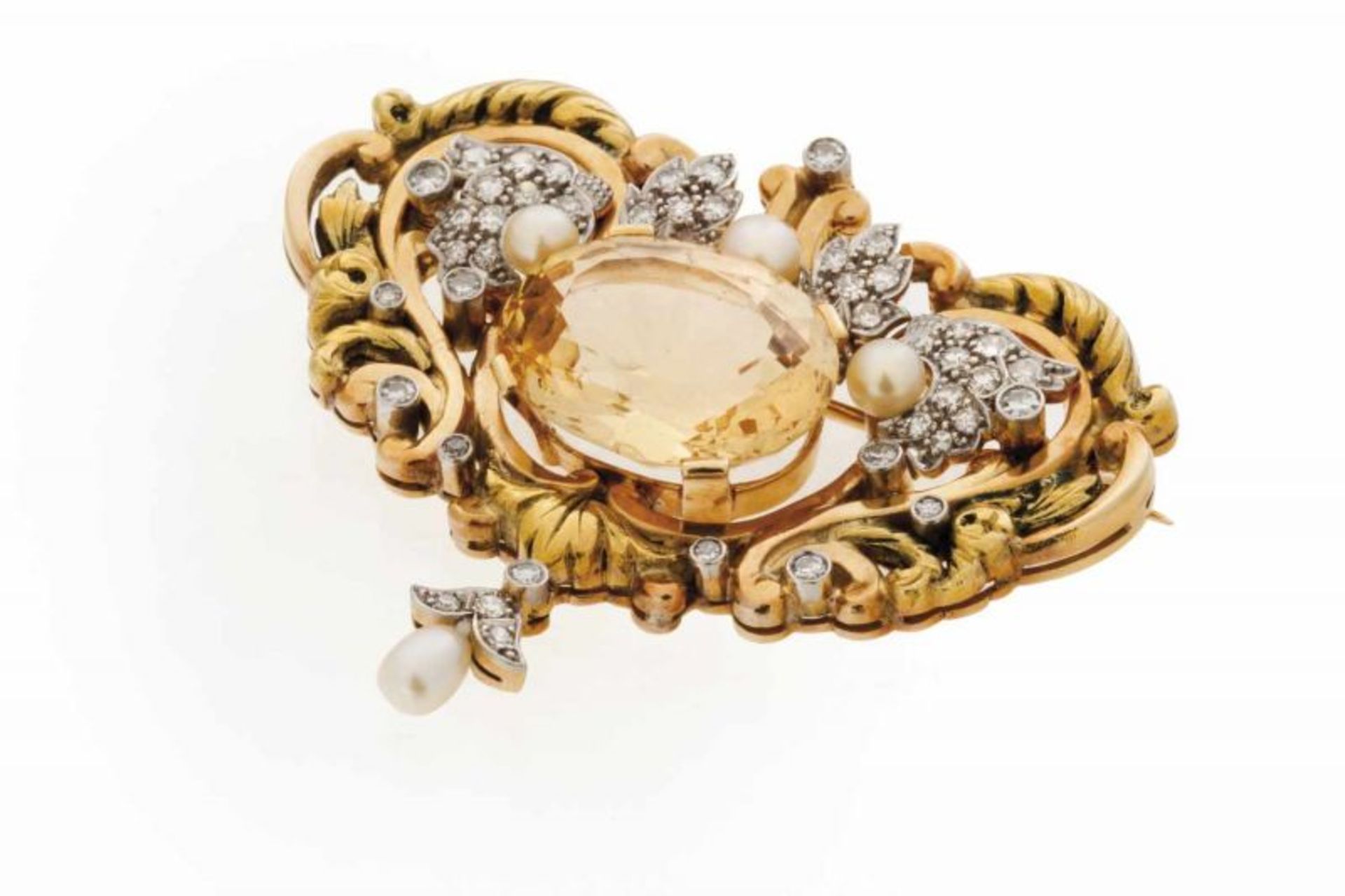 A Retro brooch Set in gold and platinum Designed as a baroque cartouche with volutes and floral