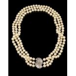 A three row pearl necklace Three rows of cultured pearls (7,5~8,00 mm), white gold clasp set with