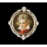 A pendant/ brooch Two-toned gold Centre with miniature depicting Beethoven and frame set with