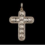 A cross-shaped pendat 14kt gold and silver set with single cut diamonds and foiled irregular cut