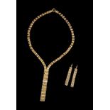 A necklace and a pair of earrings Gold decorated with polished discs and beads, fringe finials and