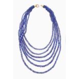 A six-strand necklace Tanzanite faceted beads of decreasing size Gold clasp Portuguese assay mark (