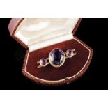 A Romantic brooch Set in gold with three oval cut amethysts Europe, second half of the 19th