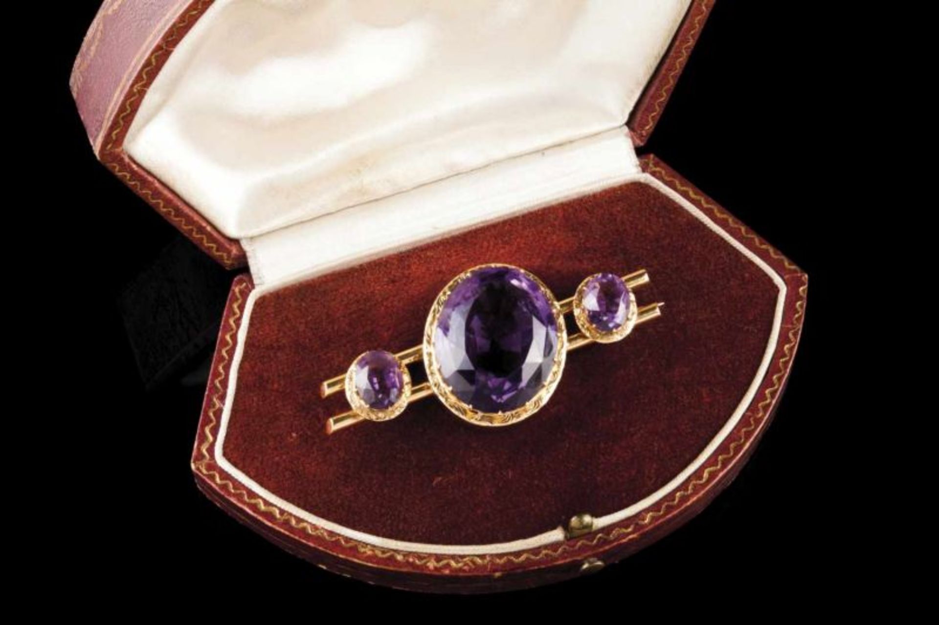 A Romantic brooch Set in gold with three oval cut amethysts Europe, second half of the 19th