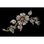 A "tremblant" brooch 14kt gold and silver set with one cabochon ruby and approx. 115 brilliant cut