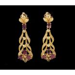 A pair of earrings Set in gold with small single cut diamonds and eight oval cut pink sapphires