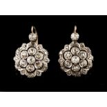 A pair of earrings Set in silver and gold with rose cut diamonds and four old mine cut diamonds