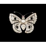 A "butterfly" brooch Set in platinum with half-pearls, four sapphires, two rubies and single cut