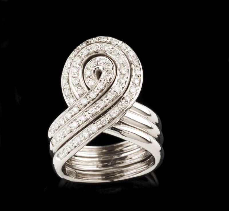 A "puzzle" ring Set in gold with 61 brilliant cut diamonds (ca. 0,50ct) Three chained "knot" rings
