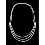 A diamond three row necklace Set in platinum and white gold with 372 princess cut diamonds (ca. 32,