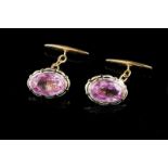 A pair of cufflinks Enamelled gold set with two oval cut pink pastes Work of the late 19th, early
